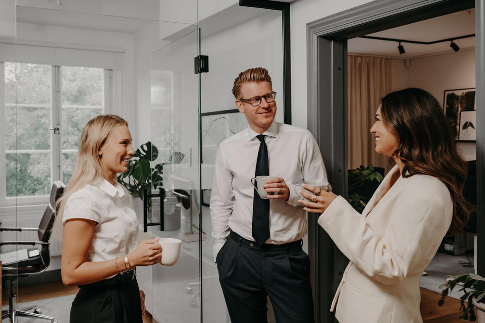Tre medarbetare från Ceteri som pratar över en kaffe